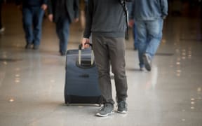Man pulling suitcase