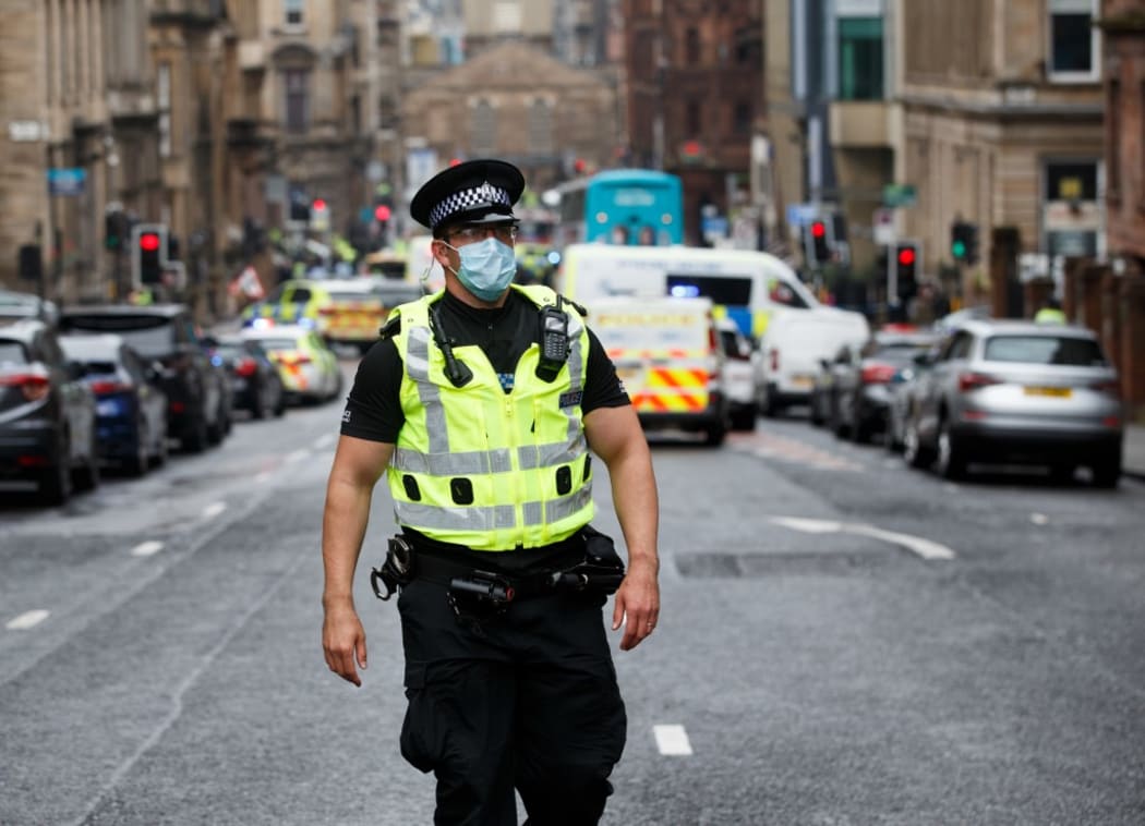 Police and emergency services respond at the scene of a fatal stabbing incident at the Park Inn Hotel in central Glasgow on June 26, 2020.