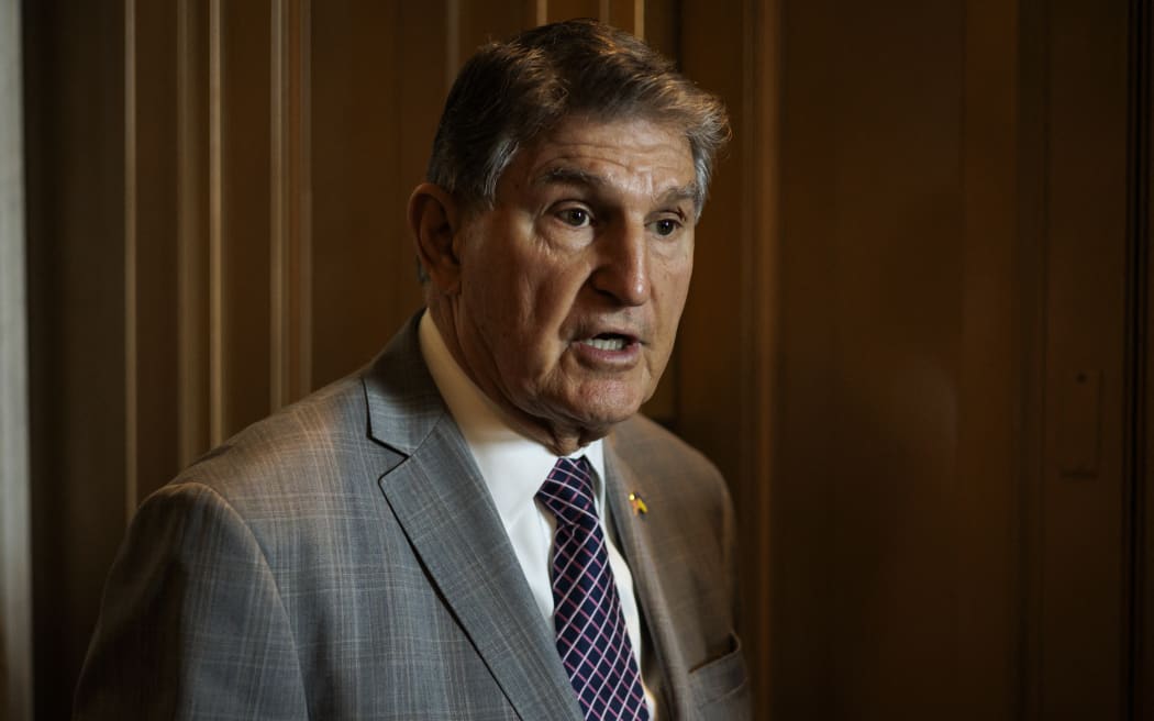 US Senator Joe Manchin (D-WV) talks to reporters as he leaves the Senate floor following a vote on 23 January, 2024 in Washington, DC.