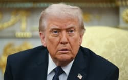 US President Donald Trump looks on during a meeting with German Chancellor Friedrich Merz in the Oval Office of the White House in Washington, DC on March 3, 2026. Chancellor Merz is the first European leader to visit President Trump since the United States and Israel launched their war against Iran. (Photo by ANDREW CABALLERO-REYNOLDS / AFP)