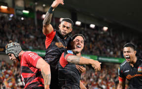Quinn Tupaea and Gideon Wrampling celebrate.