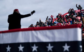 Donald Trump waves to supporters in Washington, Michigan.