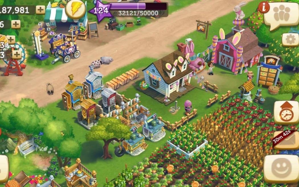 A screenshot of Farmville. It shows fields filled with crops, machines, and stalls selling produce.