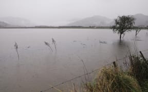 Surface flooding across Riwaka, just before the intersection to Tākaka and Kaiteriteri.