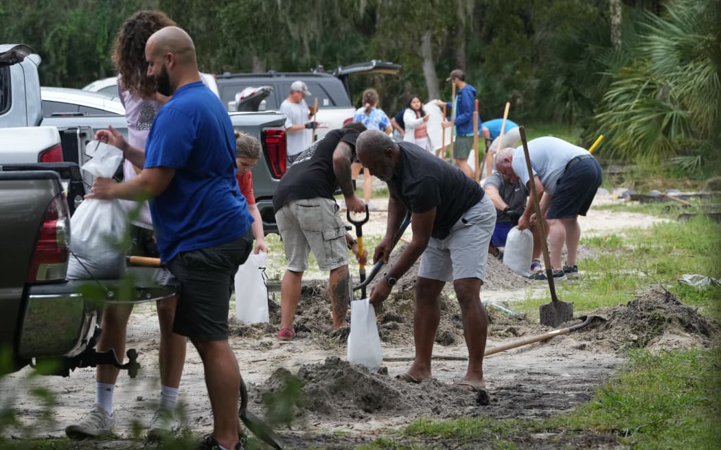 Pinellas County residents fill sandbags at John Chestnut Park in Palm Harbor, Florida on October 6, 2024. Florida's governor has declared a state of emergency on Saturday as forecasters warned that Hurricane Milton is expected to make landfall later this week. (Photo by Bryan R. SMITH / AFP)