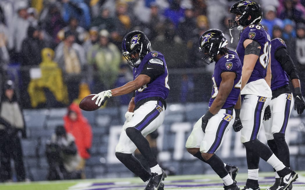Isaiah Likely #80 of the Baltimore Ravens celebrates with teammates after a touchdown in the second quarter of a game against the Pittsburgh Steelers at M&T Bank Stadium.