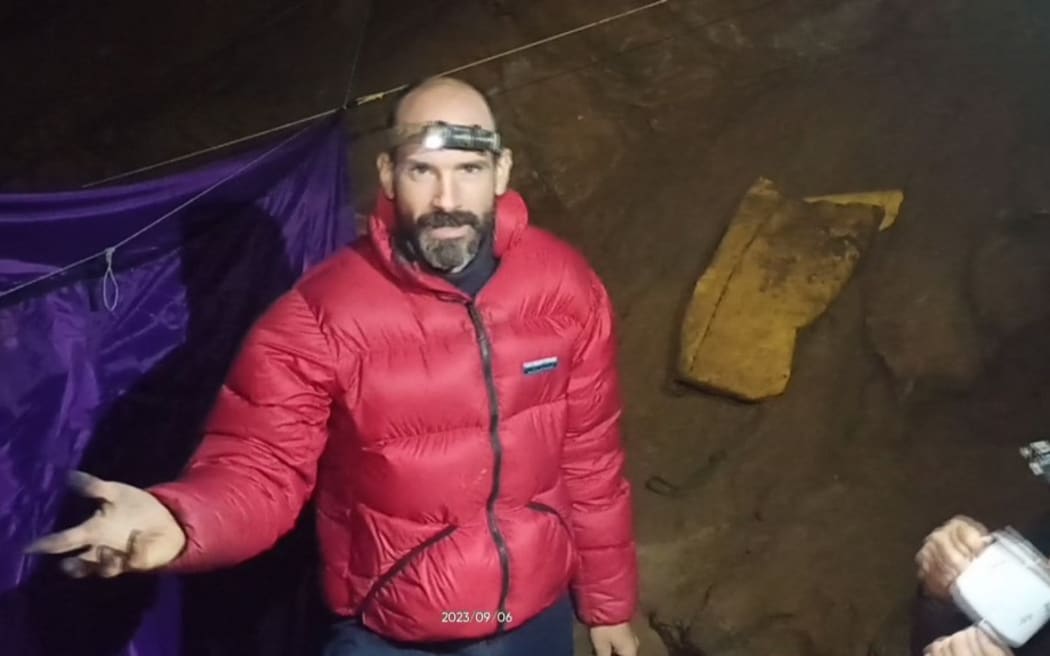 US caver Mark Dickey speaks to the camera while standing at a camp in the Morca Cave of the Taurus Mountains in southern Turkey. A US explorer trapped deep in a Turkish cave with internal bleeding said in a video released to AFP on Friday that he needed "a lot of help" getting out. Mark Dickey, 40, reported falling sick on September 2, while exploring the Morca Cave in southern Turkey's Taurus Mountains with an international team. Dickey fell ill at a depth of 1,120 metres (3,675 feet) and has been resting at a base camp located 1,040 metres underground. (Photo by HANDOUT / TURKISH DIRECTION OF COMMUNICATION / AFP) / RESTRICTED TO EDITORIAL USE - MANDATORY CREDIT "AFP PHOTO/TURKISH DIRECTION OF COMMUNICATION " - NO MARKETING NO ADVERTISING CAMPAIGNS - DISTRIBUTED AS...