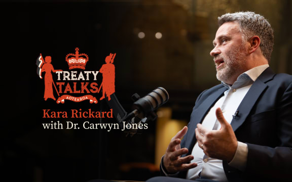 Crest referencing the nz coat of arms but featuring silhouette of a woman holding tino rangatiratanga flag and a crown with māori designs and the word Aotearoa at the base.
Colours are mainly red with some cream, all on a black background.
Text reads Kara Rickard with Dr. Carwyn Jones. 
Image of guest in conversation with host Kara (who is out of shot)