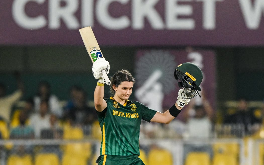 South Africa's captain Laura Wolvaardt celebrates after scoring a century against England in their Women's Cricket World Cup semifinal in Guwahati, October 29, 2025. (Photo by Biju BORO / AFP)