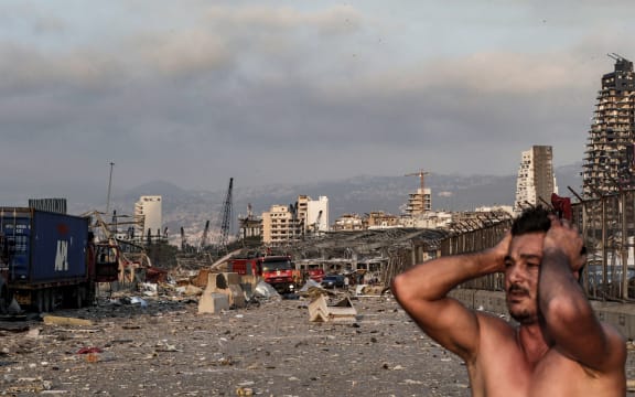A man reacts at the scene of an explosion at the port in Lebanon's capital Beirut.