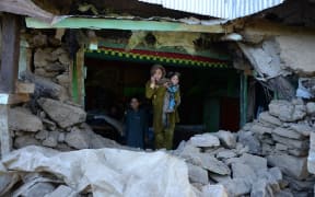Quake victims seek shelter after their home was destroyed.