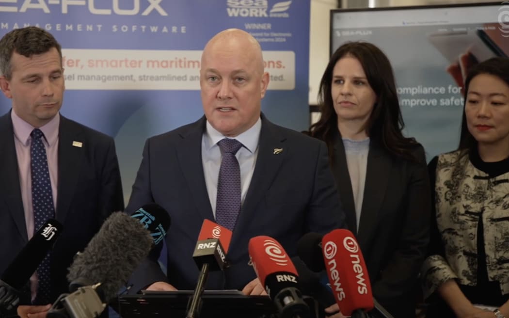 Prime Minister Christopher Luxon, centre, with Immigration Minister Erica Stanford and Associate Finance Minister David Seymour, left, announcing a new exemption to the foreign buyers' ban in September 2025.