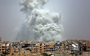 Smoke billows out from Raqqa following a US-led coalition air strike.