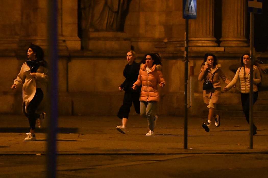 People running from the first district, in central Vienna following a shooting in the Austrian capital.