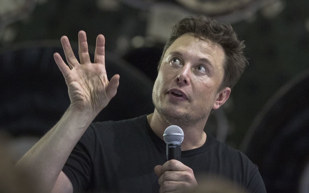 Elon Musk speaks near a Falcon 9 rocket during his announcement that Japanese billionaire Yusaku Maezawa will be the first private passenger who will fly around the Moon aboard the SpaceX BFR launch vehicle