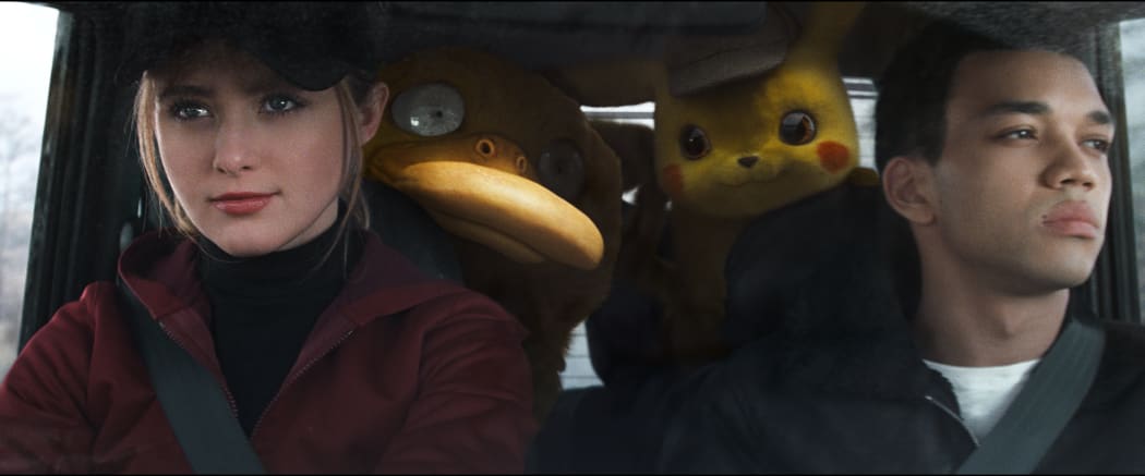 Kathryn Newton is ambitious cub reporter Lucy Stevens with Justice Smith as Tim Goodman on their way to investigate the secret Pokémon research facility which holds the key to the disappearance of Tim’s dad Harry.