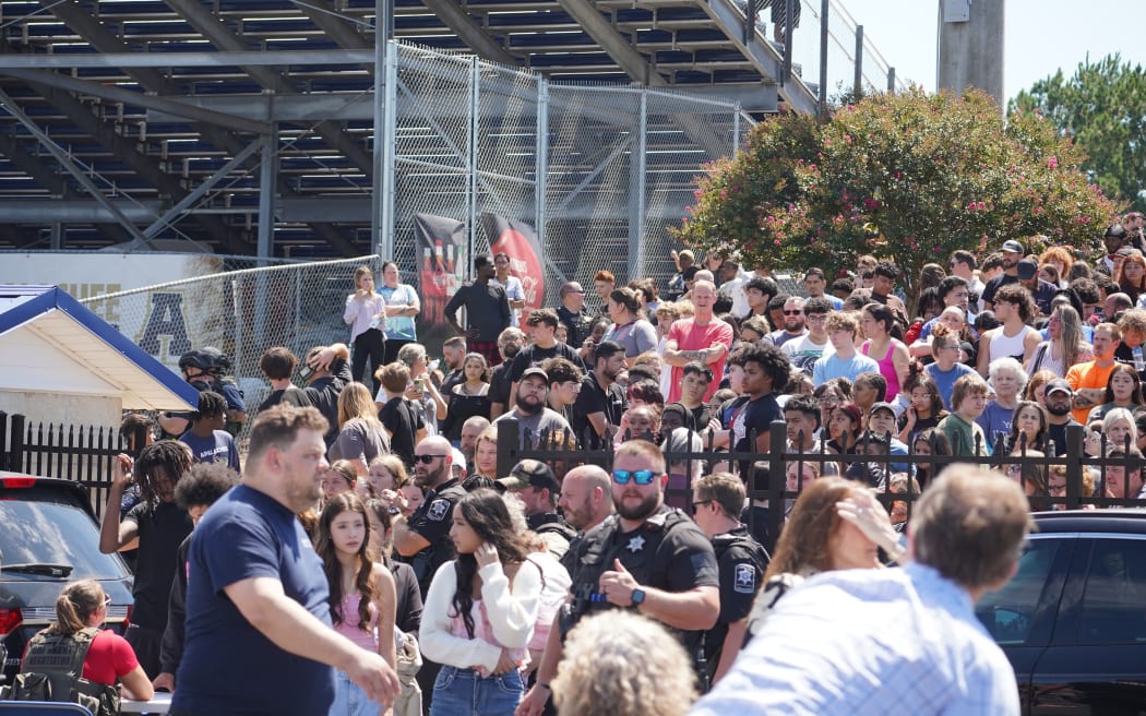 Students wait to be picked up by their parents after a shooting at Apalachee High School on September 4, 2024 in Winder, Georgia. Multiple fatalities and injuries have been reported and a suspect is in custody according to authorities.