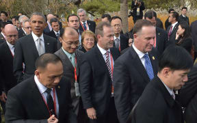 President Barack Obama with John Key as they take part in a tree-planting ceremony at APEC.