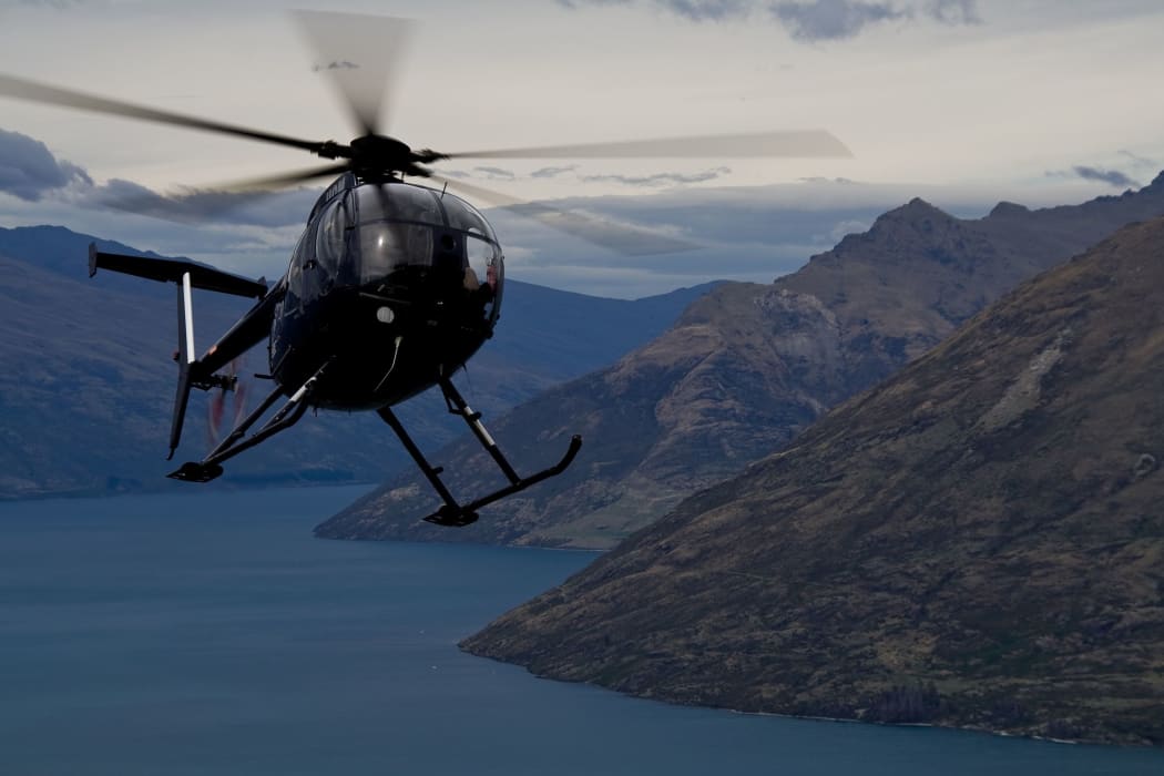 A helicopter circling over Queenstown, New Zealand.
