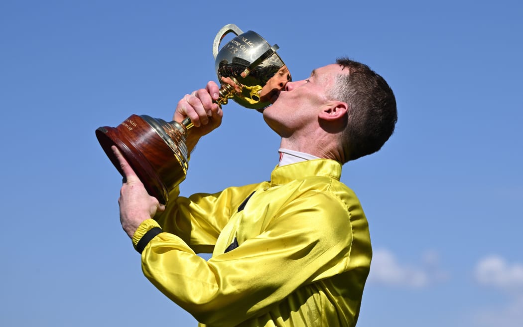 Jockey Mark Zahra kisses the Melbourne Cup after riding Without A Fight to victory.