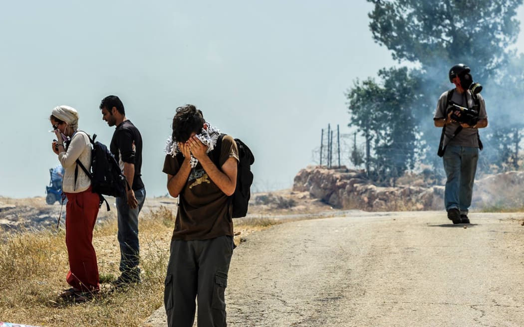 Inhaling tear gas feels like taking in fire.