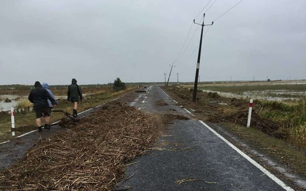 Debris cover the road in the small settlement of Kaiaua on the western side of the Firth of Thames.