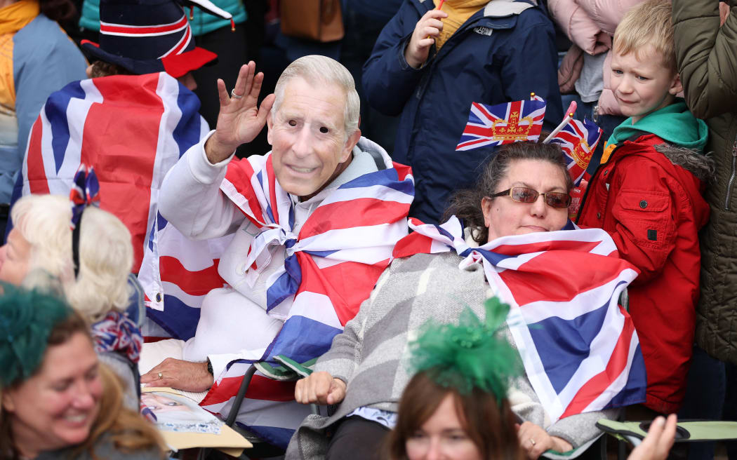 Well-wishers line the route of the 'King's Procession', a two kilometres stretch from Buckingham Palace to Westminster Abbey,  in central London, on May 6, 2023 ahead of the coronation of King Charles III. - The set-piece coronation is the first in Britain in 70 years, and only the second in history to be televised. Charles will be the 40th reigning monarch to be crowned at the central London church since King William I in 1066. Outside the UK, he is also king of 14 other Commonwealth countries, including Australia, Canada and New Zealand. Camilla, his second wife, will be crowned queen alongside him and be known as Queen Camilla after the ceremony. (Photo by Richard Heathcote / AFP)
