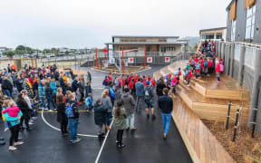 Students and staff enter Te Raekura Redcliffs School as it is reopened nine years after the Canterbury earthquakes.