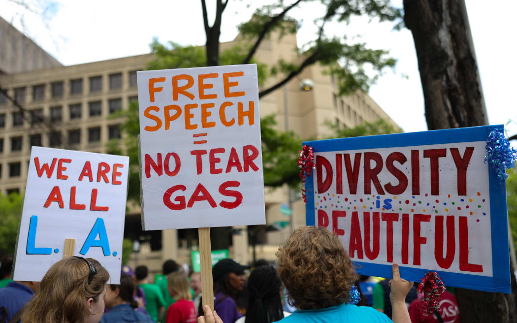 Immigrant rights supporters protest outside of the Department of Justice headquarters in Washington, D.C. on June 9, 2025. Around 1,000 demonstrators called for an end to national ICE raids and for the release of SEIU-USWW President David Huerta, who was injured and detained by federal agents during protests in Los Angeles, (Photo by Bryan Dozier / Middle East Images via AFP)