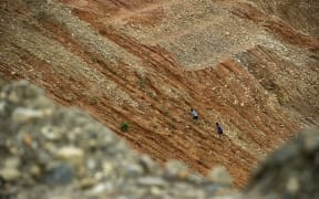 In Hpakant, Myanmar's Kachin State, every day rickety homes in a remote Myanmar village inch closer to a cliff edge as bulldozers owned by the nation's elite claw the earth beneath them, ravenously hunting jade to feed China’s multi-billion dollar demand.
