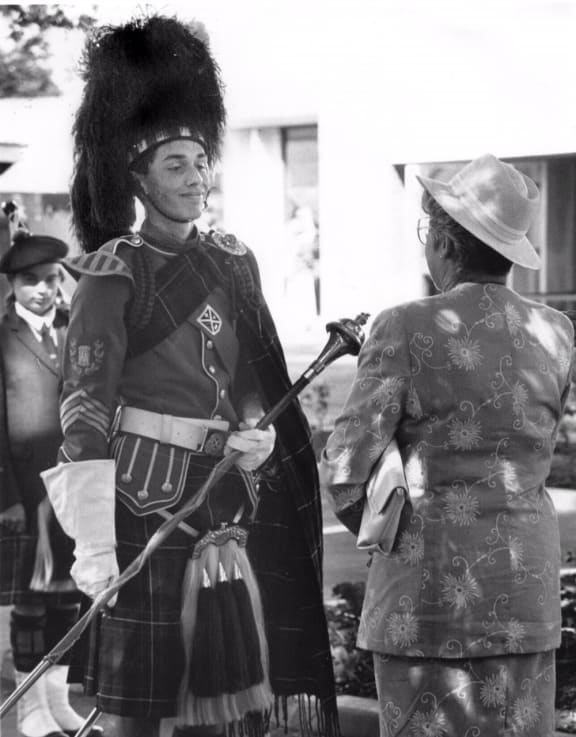 A portrait of the young Ali Ikram, dressed as drum major of the St Andrews College Pipe Band, meeting then Governor-General Dame Cath Tizard.