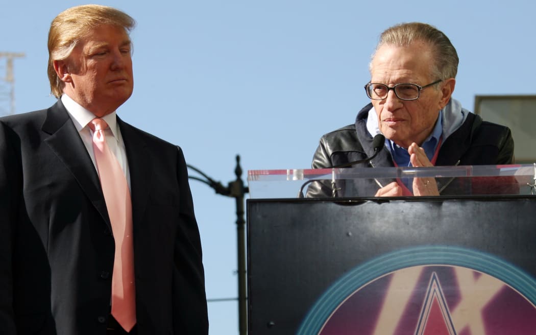 (FILES) In this file photo taken on January 16, 2007, CNN's "Larry King Live" host, Larry King (R), delivers a speech as US billionire Donald Trump (L) was honored with the 2,327th star on the Hollywood Walk of Fame on Hollywood Boulevard in Hollywood.