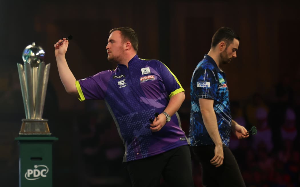 Luke Littler, left, plays Luke Humphries during the World Darts Championship final, January 2024.