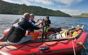Collecting lake samples.