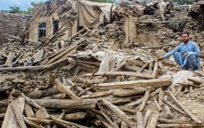 An Afghan man sits amid the remains of a damaged house, in the aftermath of an earthquake at the Dara-i-Nur district of Nangarhar province on 3 September, 2025. Hope was quickly fading of finding survivors in the rubble of homes devastated by the weekend's powerful 6.0-magnitude quake in eastern Afghanistan, as emergency services struggled to reach remote villages on September 3.