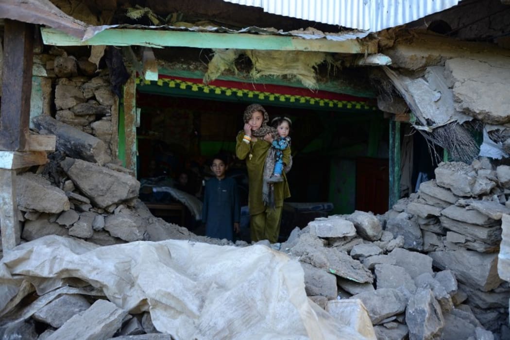 Quake victims seek shelter after their home was destroyed.