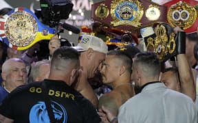 Heavyweight boxers Britain's Tyson Fury, center left, and Ukraine's Oleksandr Usyk face off during the weigh-in in Riyadh, Saudi Arabia.