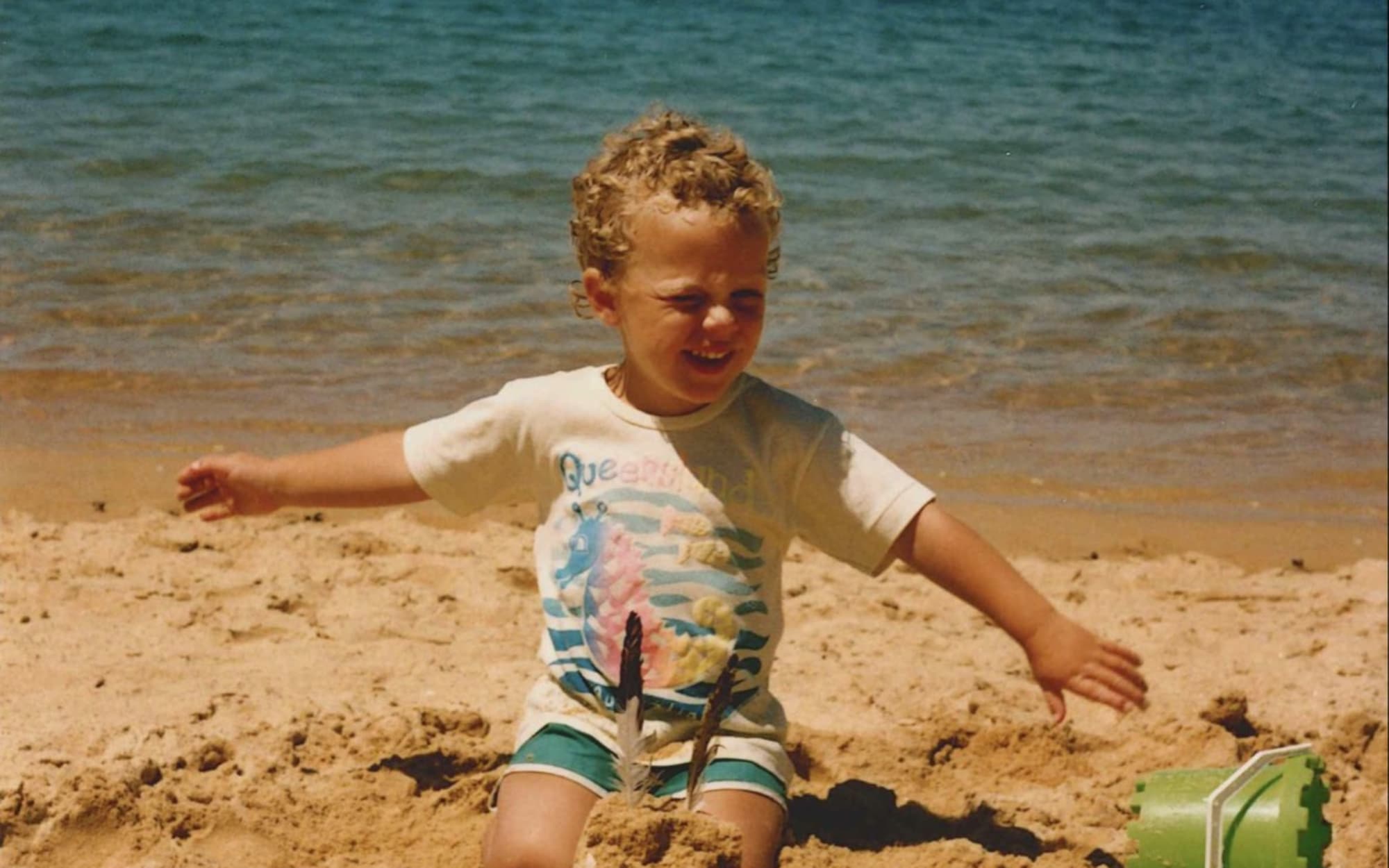 Simon Wraight as a toddler on the golden sands of Kaiteriteri.