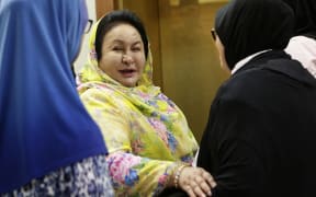 Former Malaysian prime minister Najib Razak's wife Rosmah Mansor (centre) was found guilty of three counts of receiving and soliciting bribes (file photo).