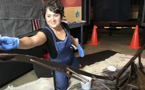 Conservator Mahshid Ezbarami works on the Parihaka plough.