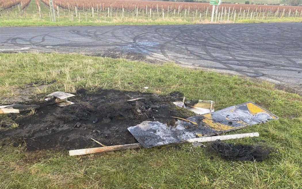 Signage from the intersection of State Highway 50 and Maraekakaho Rd, near Hastings, was burned on the side of the road, which is heavily marked with burnout damage.