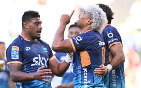 Lotu Inisi of Moana Pasifika (centre) celebrates scoring a try during the Super Rugby Pacific game against Fijian Drua, 2024.