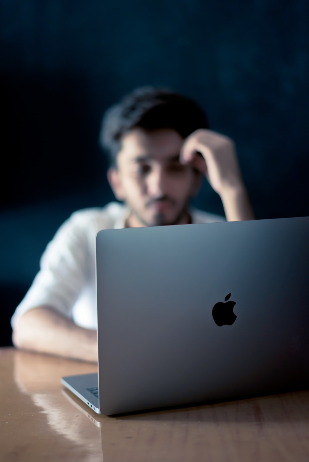 Indian man on Apple laptop