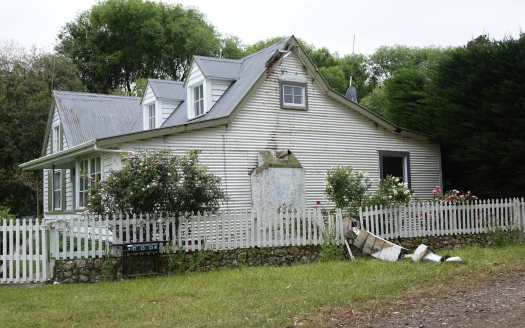 An historic cottage near Ward had its chimney ripped off in last year's quake.