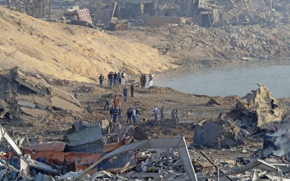 Police and forensic officers work at the scene of an explosion which took place yesterday at the port of Lebanon's capital Beirut.