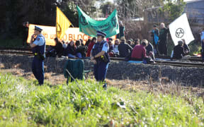 30 Extinction Rebellion members sat on the train tracks in Woolston near Christchurch on 9 August.