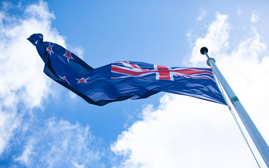 New Zealand's blue ensign does its best against a typical wellington spring day atop the Beehive, but the flag's edge edge is beginning to give way.