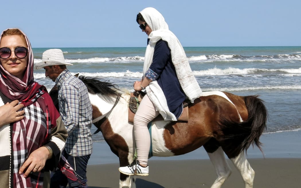 An Iranian woman rides a horse by the Caspian Sea coast in the port city of Gisum, in the northern province of Gilan in 2017.