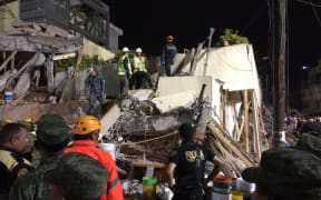 Rescue teams search overnight for survivors at Enrique Rébsamen primary school in Mexico City.