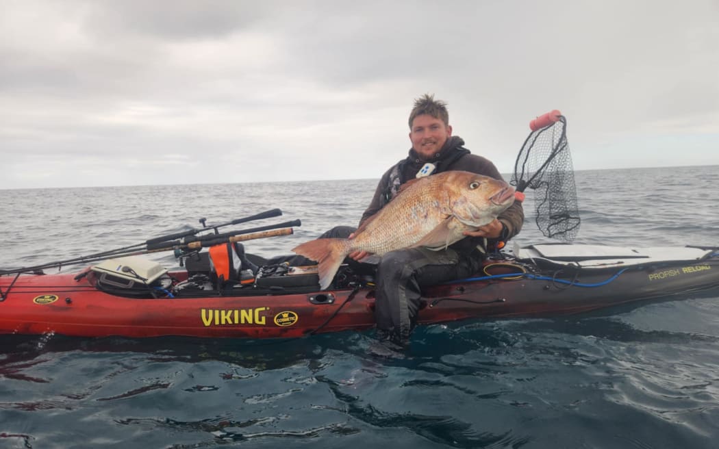 Chris Simons with the snapper he caught off the South Taranaki coast.